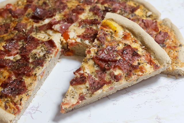 Eggs & Bacon Oat Crust Breakfast Pizza | The ultimate homemade breakfast pizza! A whole grain crust topped with eggs, bacon, cheese, and veggies for a delicious morning meal that will get you excited to wake up. Gluten-free and low-fat!