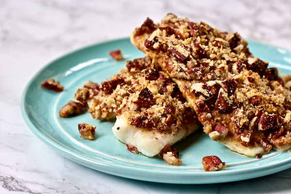 Pecan Parmesan Crusted Dijon Tilapia | Crunchy pecans combine with savory cheese to create a delicious topping for flavorful tilapia fillets! This main dish is perfect for a quick, healthy weeknight meal and will impress even non-seafood lovers.