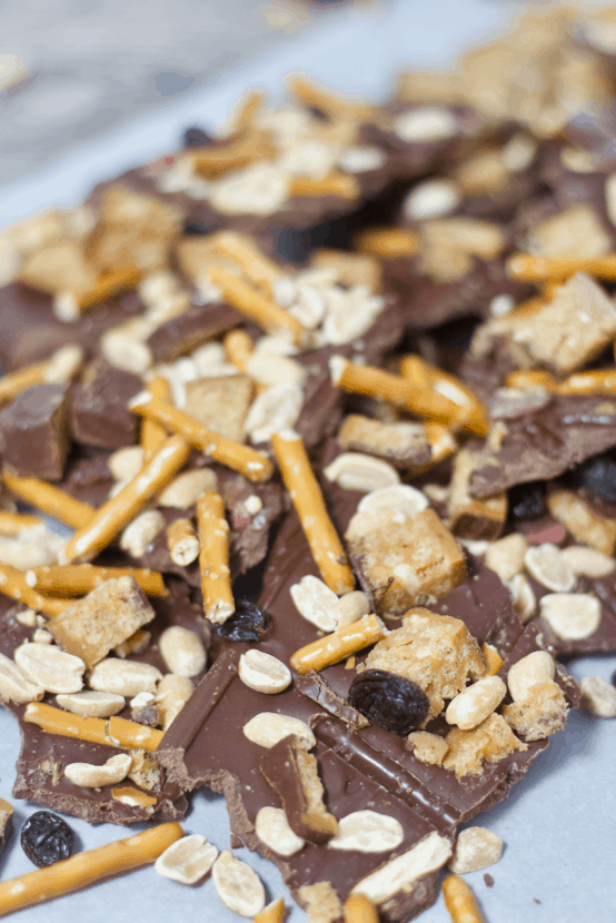 Chocolate Peanut Butter Trail Mix Bark | Healthy Helper @Healthy_Helper Deliciously rich chocolate bark swirled with creamy peanut butter and topped with all of your favorite trail mix ingredients! This easy to make treat is the perfect mix of salty n' sweet. Great for satisfying cravings and keeping you satisfied with its healthy fats and high protein content!