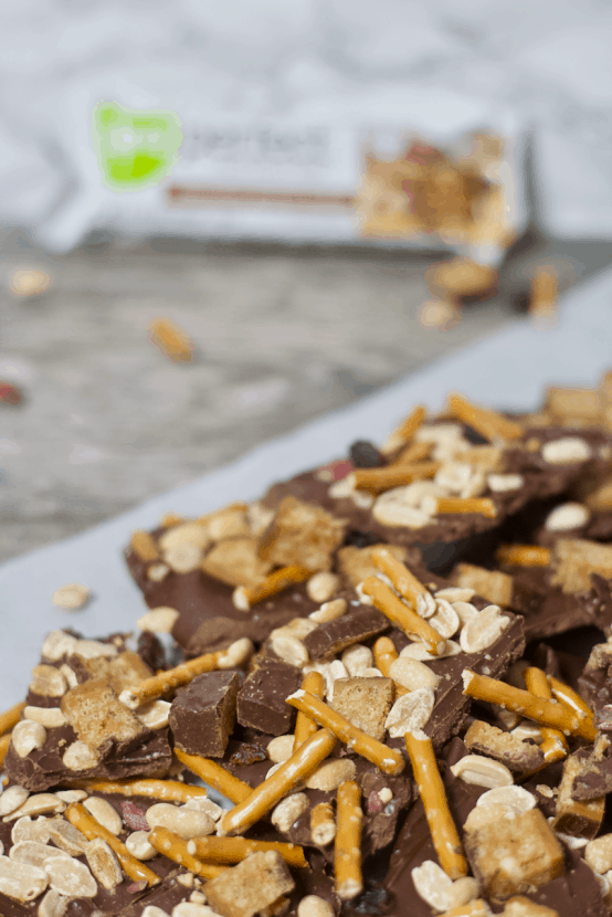 Chocolate Peanut Butter Trail Mix Bark | Healthy Helper @Healthy_Helper Deliciously rich chocolate bark swirled with creamy peanut butter and topped with all of your favorite trail mix ingredients! This easy to make treat is the perfect mix of salty n' sweet. Great for satisfying cravings and keeping you satisfied with its healthy fats and high protein content!
