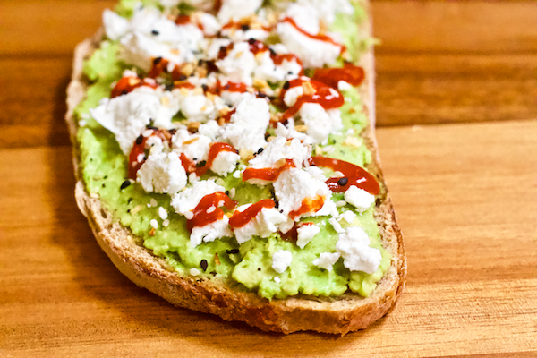 Healthy Avocado Toast - 2 Ways | Delicious, flavorful, and FRESH avocado toast made in two unique ways!  A Mediterranean inspired slice with olives, feta, & roasted red peppers and a sriracha & goat cheese variety with just the right amount of spice. You'll never be bored by avocado toast again!