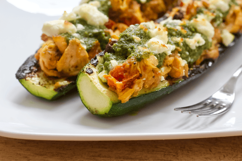Grilled Mediterranean Zucchini Boats | Summertime means it's grilling season! Fire up the grill and escape to a mediterranean oasis with these Grilled Mediterranean Zucchini Boats. Stuffed with humus, olives, roasted tomatoes, and cedar plank salmon....they are a taste and texture delight!